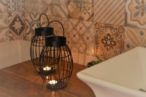 two black wire lanterns sitting on a table at Entre Fincas in Maipú