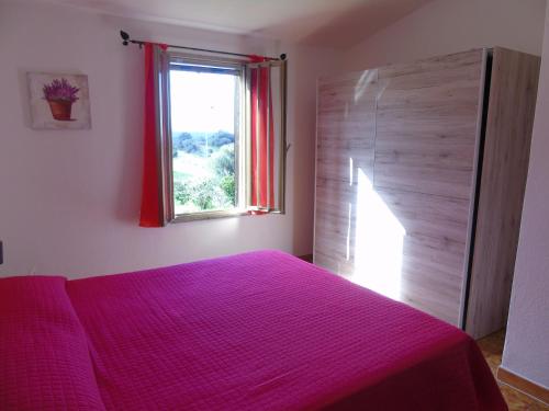 サンタ・テレーザ・ガッルーラにあるCasa Sofiaのベッドルーム1室(ピンクベッド1台、窓付)
