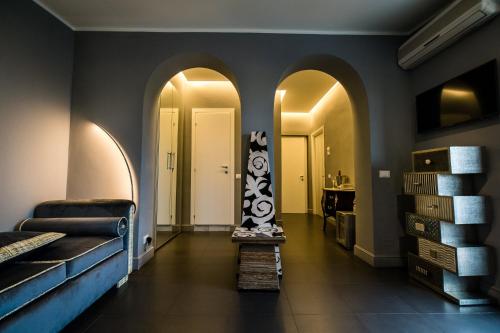 a hallway with arches and a room with a bed at Hotel Antica Locanda in Rome