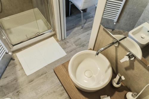 a bathroom with a toilet and a sink and a mirror at VILLA FENIX OSIO SOTTO in Osio Sotto