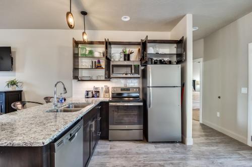 a kitchen with a white refrigerator and a sink at Watchman Villas in Springdale