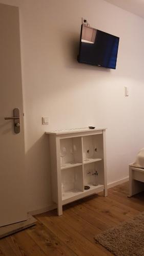 a living room with a tv on a wall at Miniapartment am Dalberg in Aschaffenburg