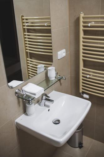 a bathroom with a white sink and a mirror at Penzion Štybar in Stříbro