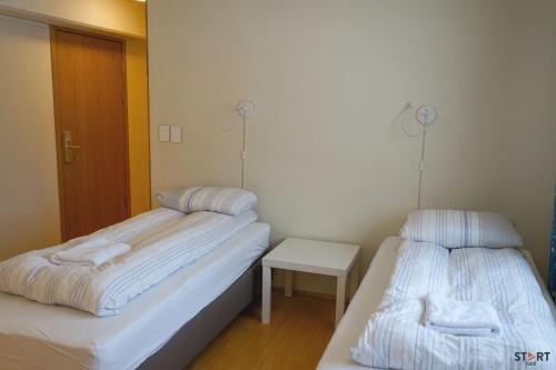a room with two beds with towels on them at Start Keflavík Airport in Keflavík
