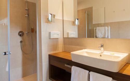 a bathroom with a sink and a shower at feldthurnerhof vinum-natur-relax in Feldthurns