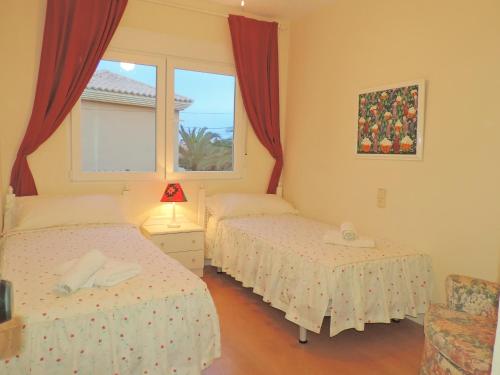 a bedroom with two beds and a window at chalet privado en Cabo de Palos in Cabo de Palos