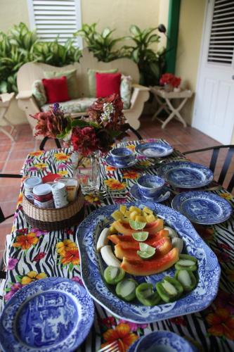 a table with blue plates of food on it at Colleton Great House in Saint Peter