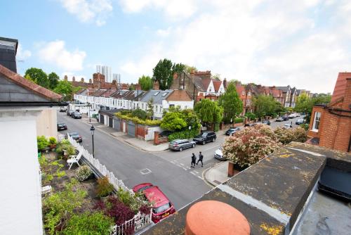 a view of a street in a town with buildings at Great Loft & Location by Belsize Park tube in London