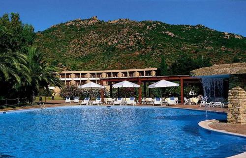 a large swimming pool with a mountain in the background at Villa Oleandro in Pula