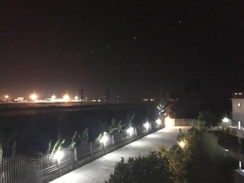 a bridge lit up at night with lights at Rung ChiangRai Resort in Chiang Rai