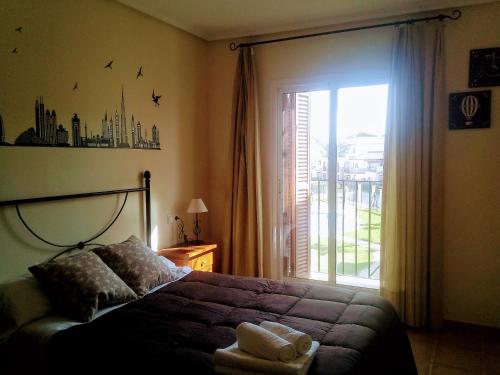 a bedroom with a bed and a large window at Al-Andalus Thalassa Home Star in Vera