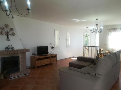 a living room with a couch and a fireplace at Casa Ayo in Frigiliana