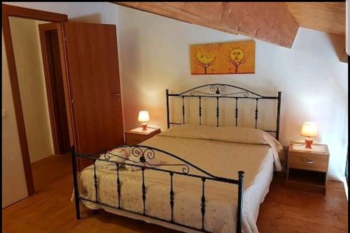 a bedroom with a bed and two lamps on tables at Casa Vacanza Brigida in Scopello