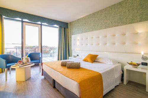 a hotel room with a large bed and a large window at Hotel Viest in Vicenza