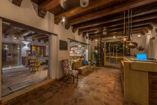 a restaurant with a lobby with a bar and chairs at Getsemani Cartagena Hotel in Cartagena de Indias