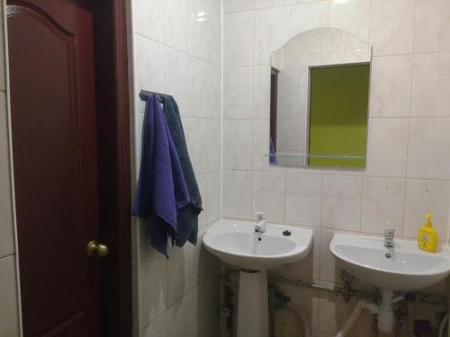 a bathroom with two sinks and a mirror at Yourhostel Дорогожичи in Kyiv