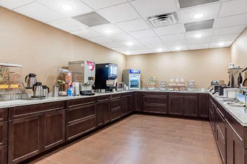 a large kitchen with wooden cabinets and a counter top at Comfort Suites in La Vista