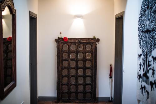 an old wooden door in a room with a light at Molino Monacelli Country House in Fano