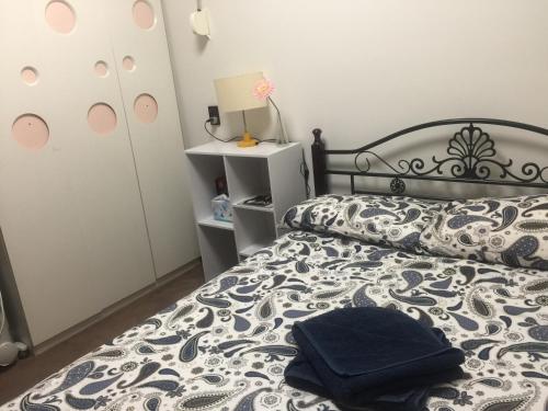 a bedroom with a bed with a black and white comforter at No 96 in Melbourne