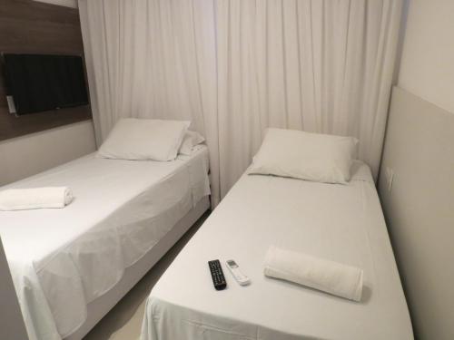 A bed or beds in a room at Flat Recife Hotel & Convention