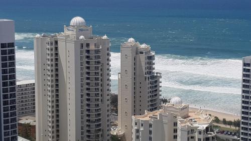 a group of tall buildings next to the ocean at APR Private SUITES MOROCCAN by the Beach in Gold Coast