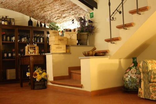 a wine tasting room with a staircase in a building at Locanda San Barnaba in Scarperia