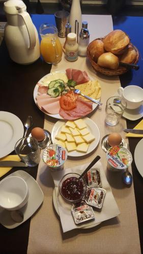 a table topped with plates of food and bread at Casalino in Wachtendonk