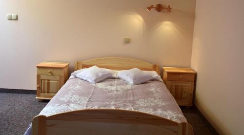 En eller flere senge i et værelse på Apartamenty Pod Jesionem