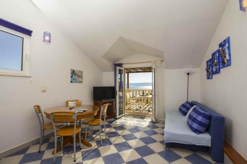 a living room with a table and a couch at Apartmani Sani Bol in Bol