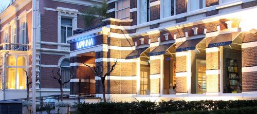 a facade of a building with sunlight shining on it at Hotel Manna in Nijmegen