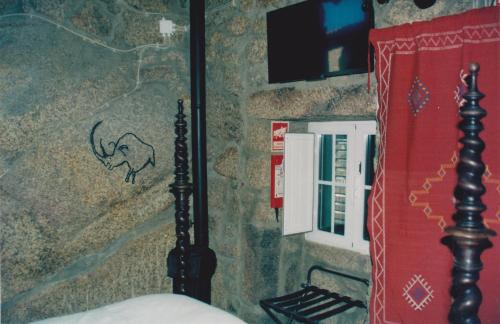 モンサントにあるCasa da Gruta (Cave House)の象の絵が描かれた壁のベッドルーム