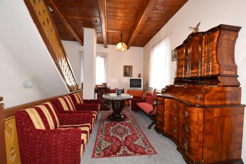 a living room with chairs and a table in a room at Penzión Villa Breza in Vysoke Tatry - Novy Smokovec