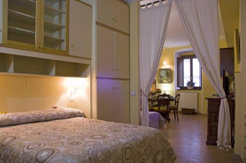 a bedroom with a bed and a dining room at Casa Aurora in Assisi