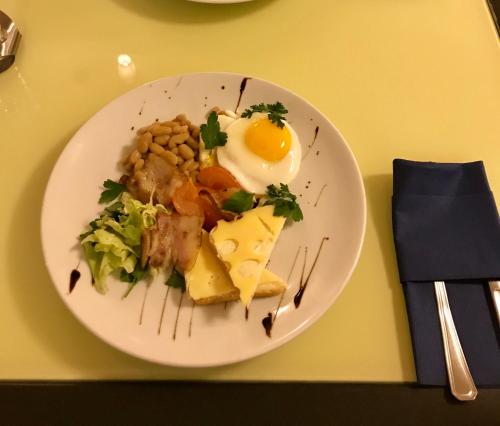 a plate of food with an egg on a table at Non-stop Economy hotel in Boryspilʼ