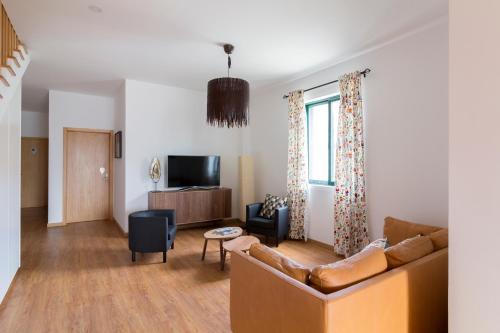 a living room with a couch and a tv at H18 in Horta