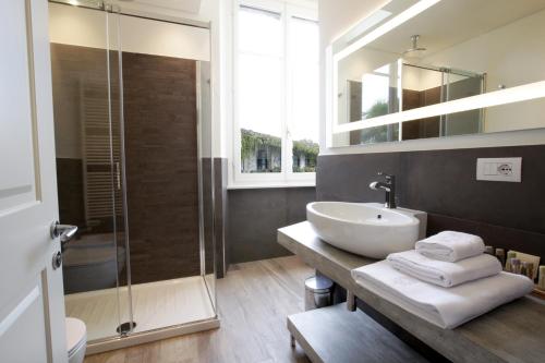 a bathroom with a sink and a glass shower at Villa Liberty in Como