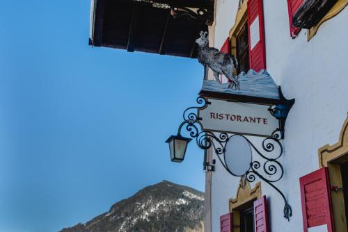a street sign on the side of a building at Posthotel Sachrang in Sachrang