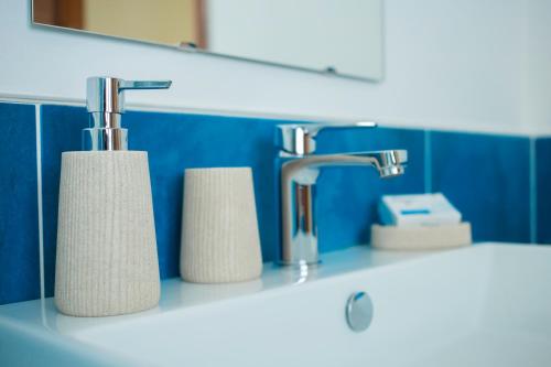 a bathroom with two rolls of toilet paper on a sink at Sandalia B&B in Lotzorai