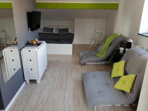 a small living room with a couch and a bed at Le Manoir de Champlan in Grimisuat