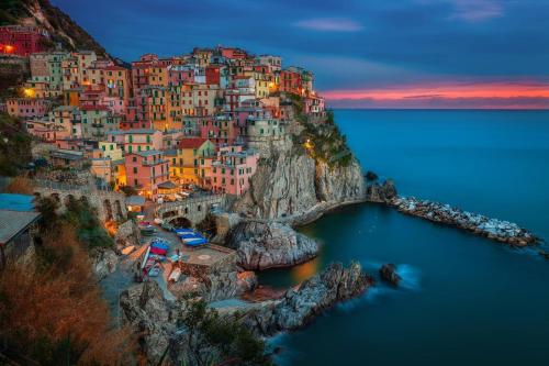 a view of a town on a cliff in the water at Hotel La Vigna in Moneglia