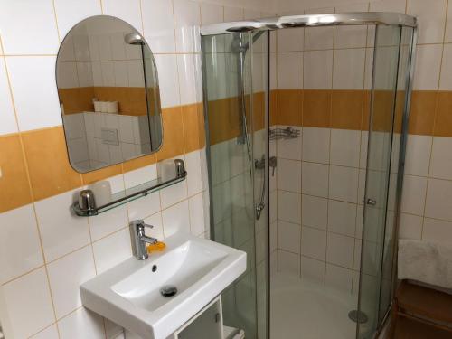 a bathroom with a sink and a shower at Pension Na Vyhlídce in Český Krumlov