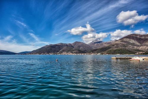 a view of a large body of water with mountains at Villa Ruza, Donja Lastva in Tivat