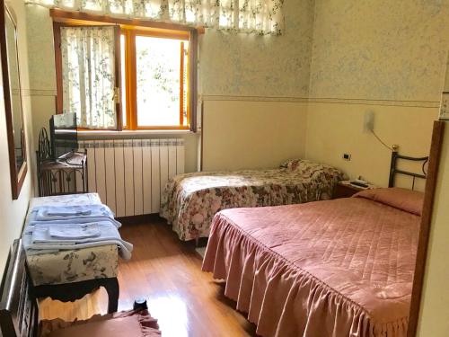 a room with two beds and a window at B&B La Vela 2 in Rieti