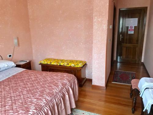 a bedroom with a bed and a bench in it at B&B La Vela in Rieti