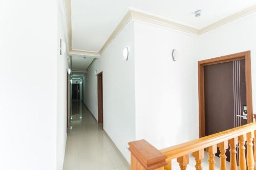 a hallway of a house with a wooden staircase at Résidence Hôtelière Le Jomonia in Libreville