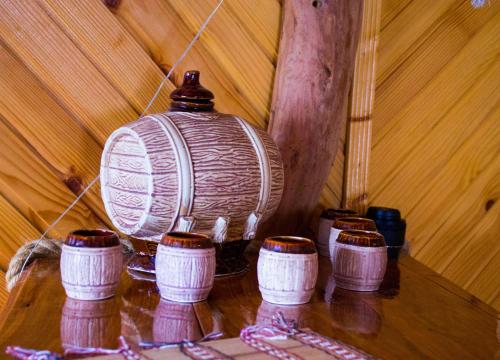 a group of cups sitting on a wooden table at Dachna Sadyba PB in Migovo
