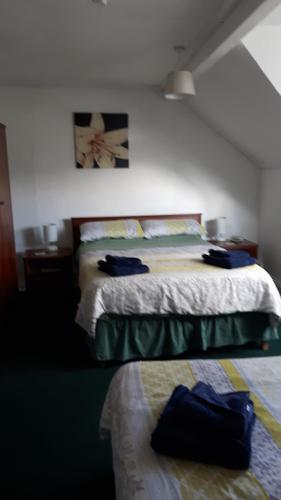 een slaapkamer met een bed en een nachtkastje en een bed sidx sidx sidx sidx bij Victoria Inn in Alston