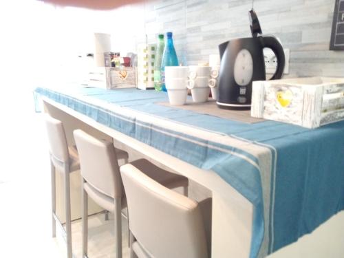 a table with chairs and a blue table cloth at Bed and Breakfast Bio Salix in Padova