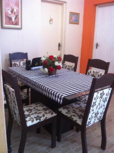 a dining room table with a black and white table cloth at Hostel Itanhaém in Itanhaém
