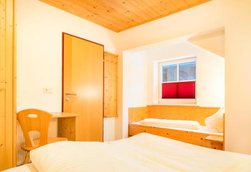 a bedroom with two beds and a window at Hansalagut in Mauterndorf